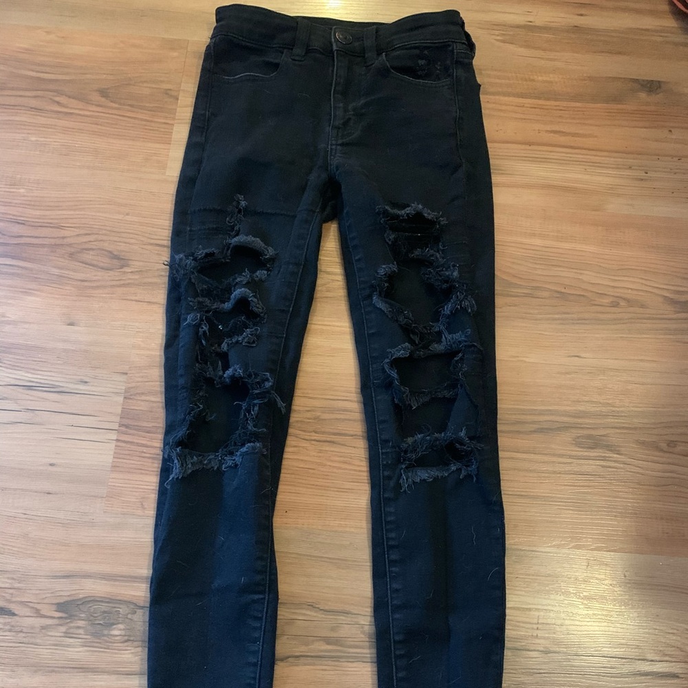 Women’s black ripped skinny jeans.